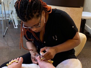 Photograph of Simone Renee Moore clipping toenails