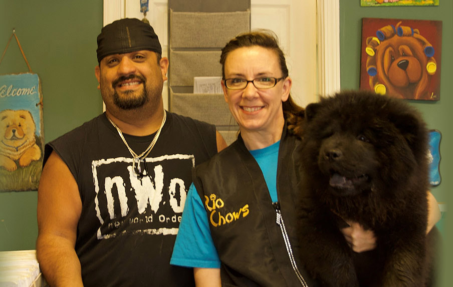 Photograph of Brian and Jackie posing with one dog