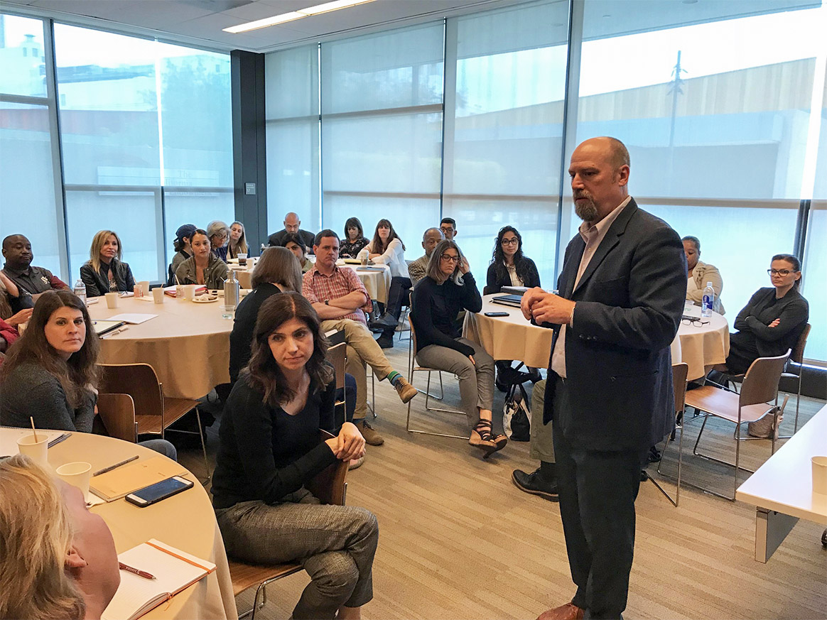 Photograph of Doug Crandell speaking to a group of people