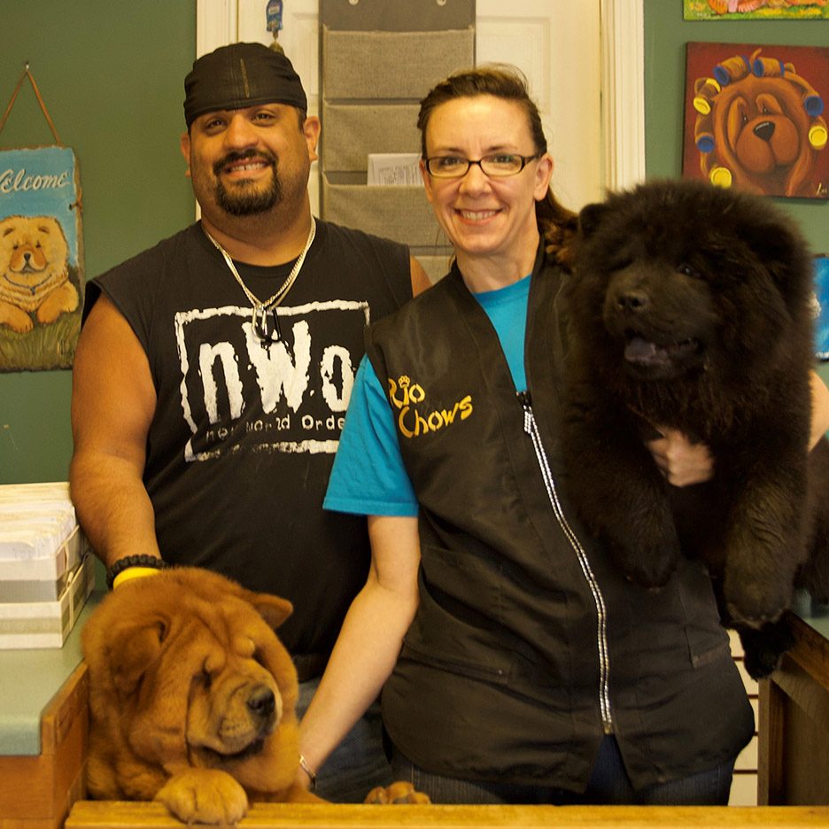 Photograph of Brian and Jackie posing with two dogs